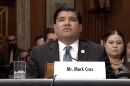 Man at a table with a title card that says Mr. Mark Cruz.