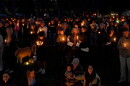 People gather for a candlelight vigil held in Drake Park in Bend, Ore., Oct. 15, 2026, following the shooting at Silver Rail Elementary School earlier in the day.