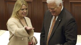 Florida attorney general and elector Pam Bondi, left, and secretary of state Ken Detzner confer before electoral members cast their presidential ballots at the state Capitol, Monday, Dec. 19, 2016, in Tallahassee, Fla. (AP Photo/Steve Cannon)