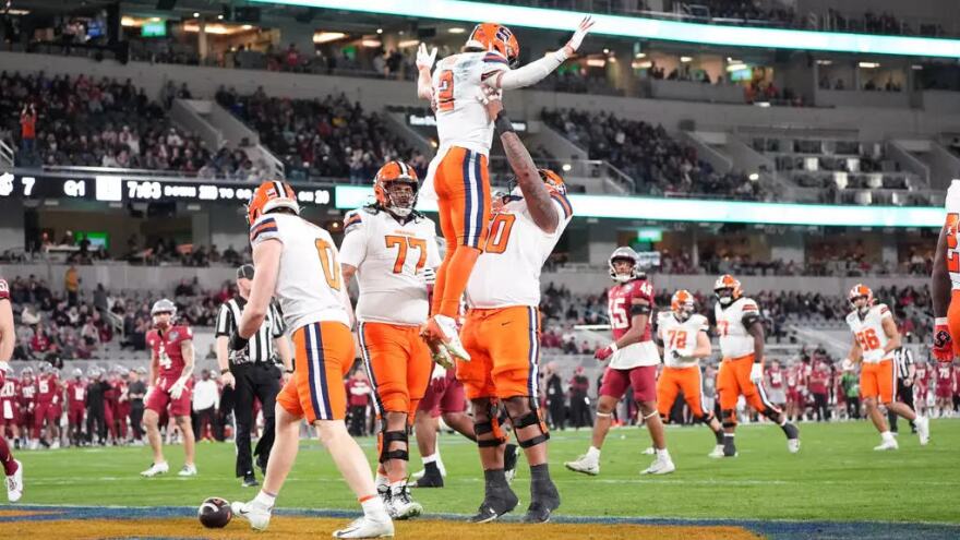 Trebor Pena (2, White) celebrates with the SU offensive line after a touchdown