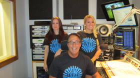 WFIT's "Expand Your Horizons" t-shirts modeled here by Michelle Walker, Todd Kennedy and Amanda Derleth.