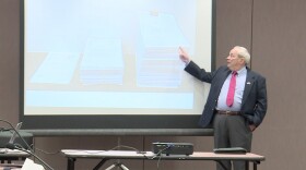 Indiana State Police Forensic Analysis Director Eric Lawrence demonstrates how much case files have grown because of recent changes to how drug crimes are prosecuted.