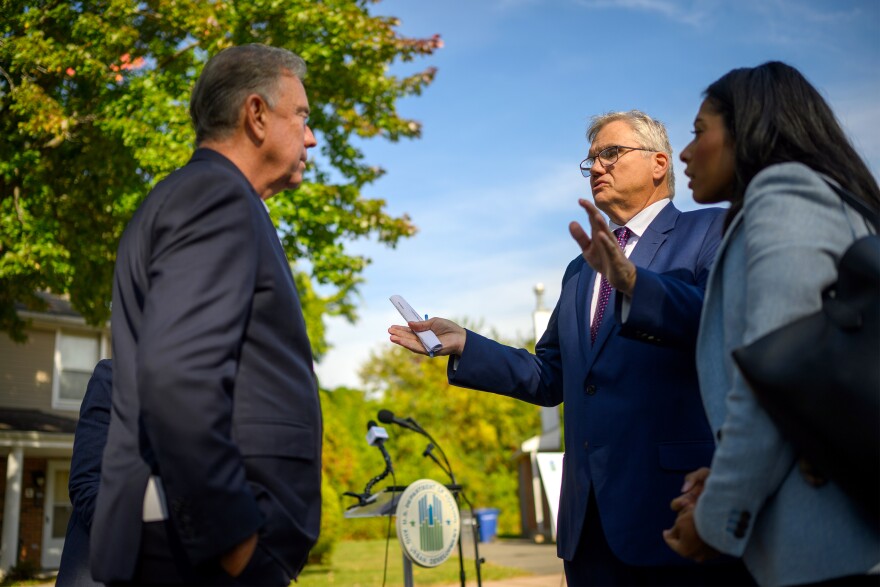 Connecticut governor Ned Lamont (left) talks with Richard Monocchio, HUD Principal Deputy Assistant Secretary for Public and Indian Housing, and Juana Matias, HUD Regional Administrator for Region 1, in front of a Hartford public housing complex after a press conference October 4, 2024, after the city received $4-million from HUD to remediate lead paint.
