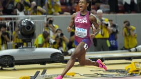 Sha'Carri Richardson, of the United States, reacts after crossing the finish line to win the gold medal in the Women's 100-meter final during the World Athletics Championships in Budapest, Hungary, Monday, Aug. 21, 2023. (AP Photo/Matthias Schrader)
