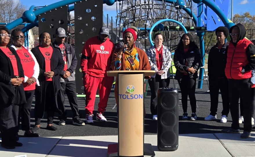 Tolson Center Board of Directors Chair Nekeisha Alayna Alexis speaks at a ribbon cutting for the center's outdoor campus on Nov. 16.