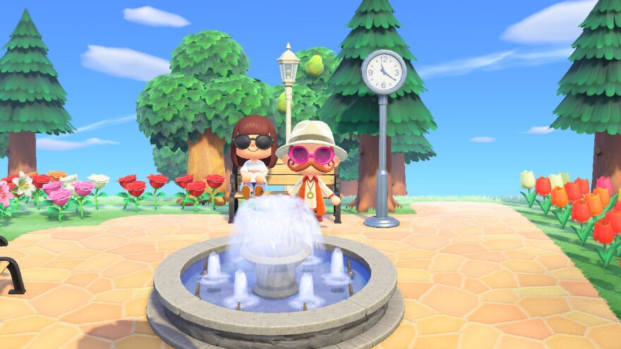 An image of two virtual characters meeting up by a fountain in Animal Crossing New Horizons.