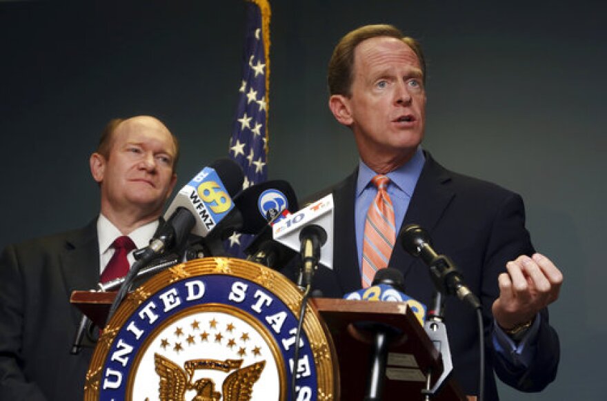  U. S. Sen. Pat Toomey, R-Pa., right, speaks during a press conference alongside U.S, Sen. Chris Coons, D-Del. Monday, March 5, 2018, in Philadelphia. Toomey and Coons say they'll introduce a bill Monday that will require federal authorities to notify states when a felon or a fugitive attempts to buy a firearm but fails the National Instant Criminal Background Check System.