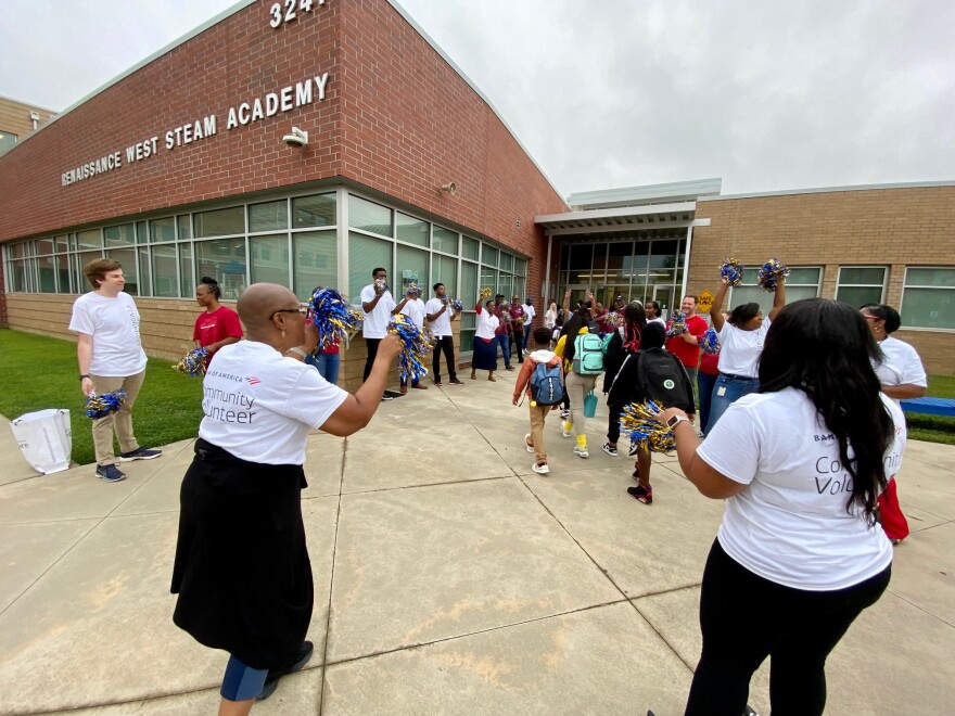 Volunteers from Bank of America and Greater Mount Sinai Baptist Church lined the entrance to Renaissance West STEAM Academy to welcome students back to school.
