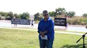New Mexico state Senator Carrie Hamblen with people holding signs opposing A.I. data centers behind her