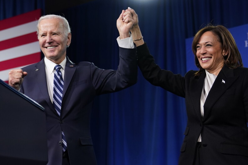 President Joe Biden, left, and Vice President Kamala Harris stand on stage at the Democratic National Committee winter meeting, Feb. 3, 2023, in Philadelphia.