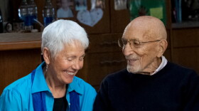 two people pose for a photo, smiling