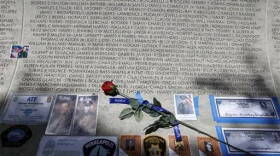 In this May 13, 2013 file photo, a rose is placed at the wall with the names of fallen police officers at the National Law Enforcement Officers Memorial in Washington during the National Police Week