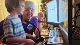 Anthony Frissell, 6, and his dad, Nathaniel Frissell, associate professor of physics and engineering at the University of Scranton, speak to Santa at the school's amateur radio station.