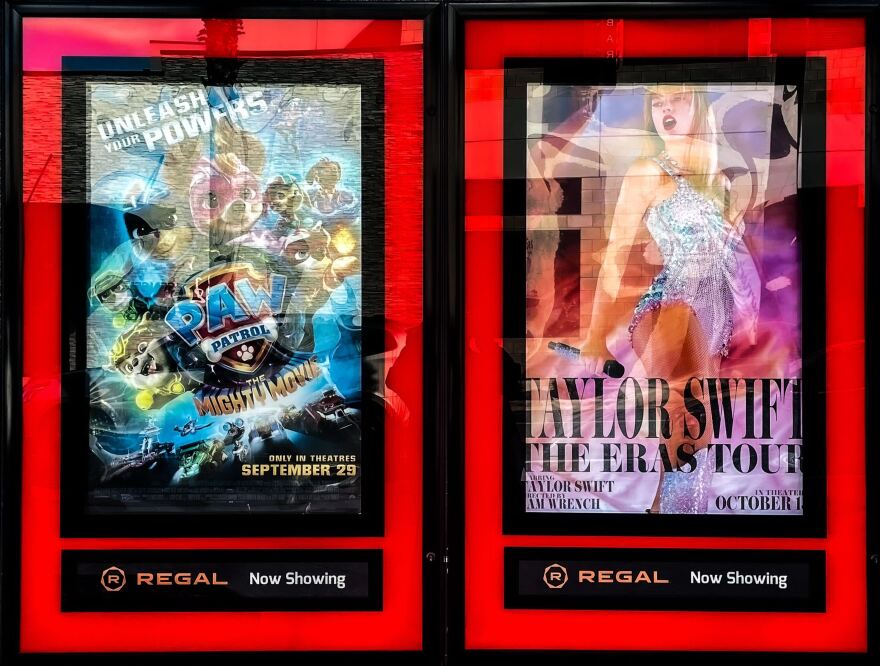 “Taylor Swift: The Eras Tour” poster, right, outside of Regal Cinemas in Gainesville, Florida, Oct. 13, 2023. (Vivienne Serret/WUFT News)