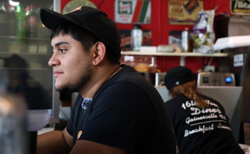 Server Derek Castillo handles a take-out order during the Sunday morning rush at 16th Avenue Diner in Gainesville, Fla. on Sunday, Nov. 16, 2025.