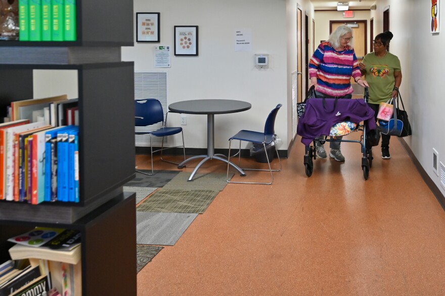 Carol Rodriguez and her caregiver Gladys Kennedy walk together after Arts for Life class.