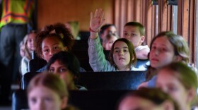 Claire Black, a fourth grader from Howard Gardner MI Charter School, raises her hand to ask questions during the Heritage Explorer Train on Friday, May 10.