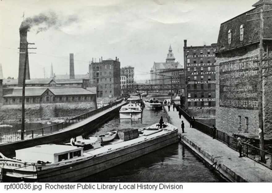 The Erie Canal, looking west, circa 1897. The Aqueduct Building is on the right in the middle. Old City Hall is in the distance to the right.