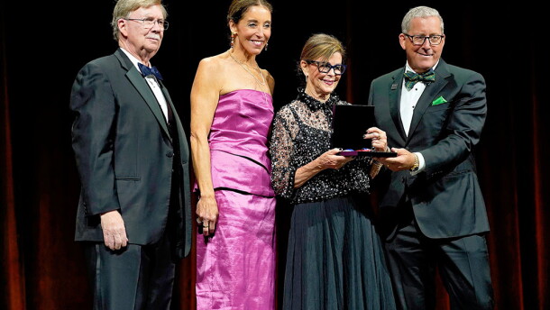 From left to right: Retired Maj. Gen. John L. Barry presents John D. Odegard's National Aviation Hall of Fame award to members of Odegard's family; daughter Stephanie Odegard LaDue, wife Diane Odegard and son John Odegard Jr.