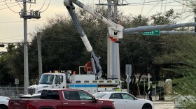 An FPL repair crew works on a connection at Alico and Oriole roads in south Lee County Sunday afternoon. Power outages affected traffic lights and up to 1,200 customers during the afternoon hours after high winds. arrived in the area.