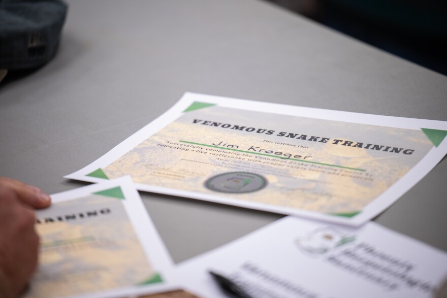 Cale Morris presents rattlesnake class attendees with certificates after class at the Florence Ely Nelson Desert Park in Scottsdale, Arizona.