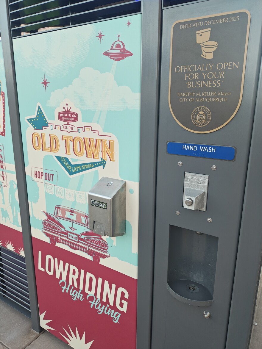 The hand washing station on the ide of the Portland Loo on Civic Plaza is supplied with heated water, which also supplies the toilet itself to prevent freezing pipes. The dedication sign, the mayor said, was added with a sense of "toilet humor."