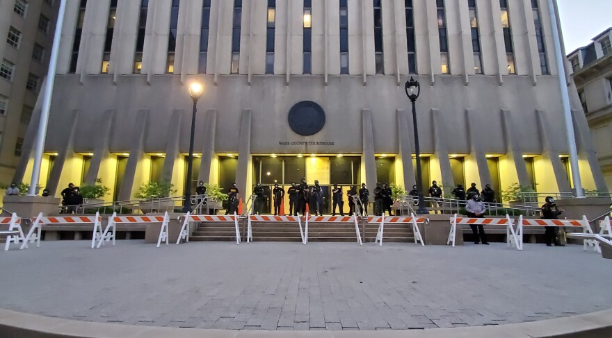  Wake County Sheriff's deputies stand guard by the Fayetteville Street Wake County Courthouse entrance on May 31, 2020.