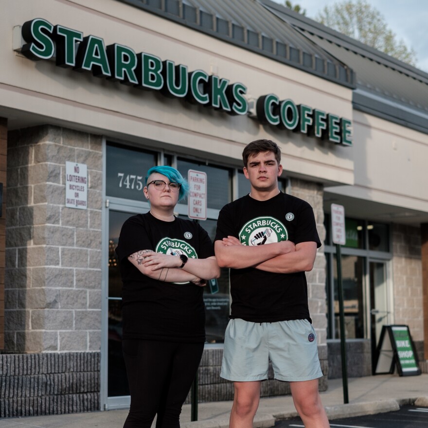 Starbucks shift supervisor Gailyn Berg and barista Tim Swicord outside of their store in Springfield, Virginia. [Michael A. McCoy for NPR]