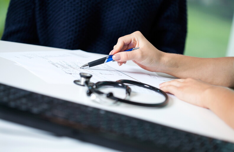 A healthcare professional goes over paperwork.