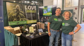 Herb Barbot, left, and Linda Baldwin stand at the Green Standard Alliance booth at the New York State Fair.