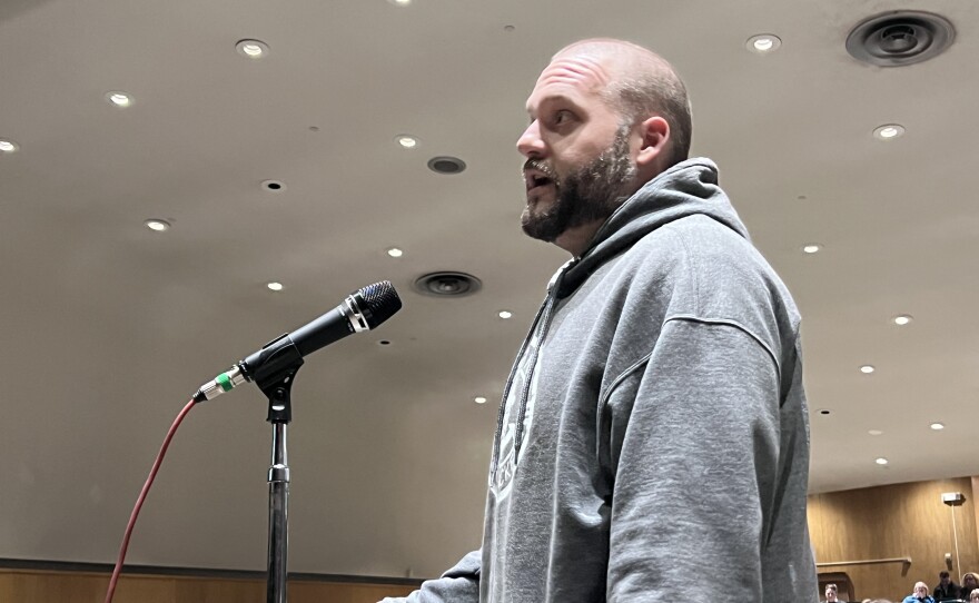 Parent Chris Bjelland speaks against the closure of Greenhaven Elementary School during the March 26, 2026, public hearing at Lincoln Middle School in Hibbing.