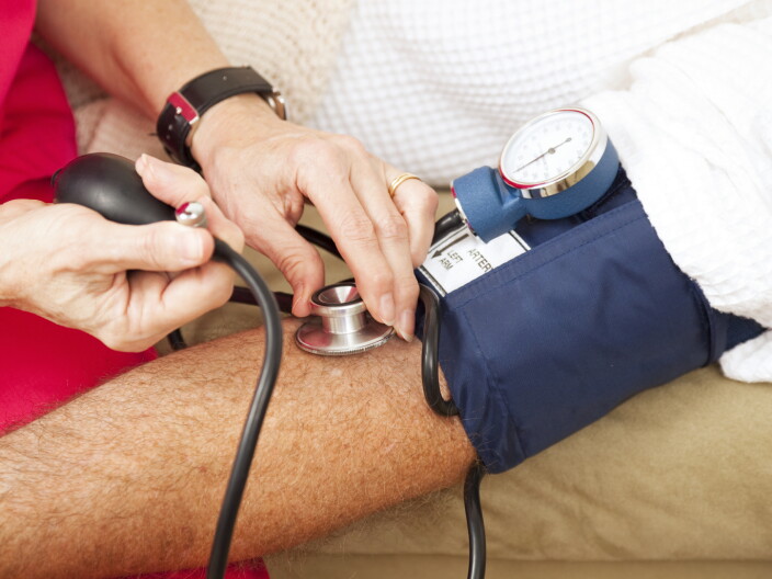 A man has his blood pressure checked.