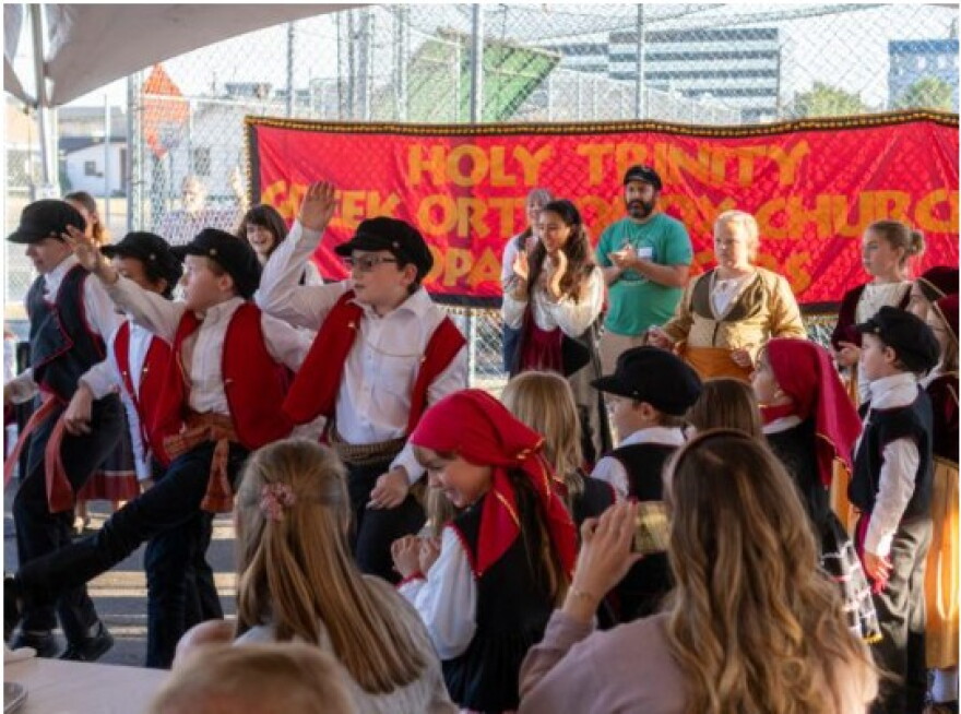 Children dressed in traditional Greek clothing dance at the annual Greek Festival.