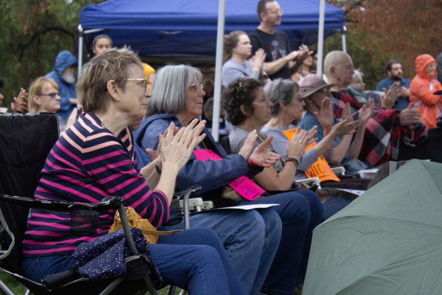 Members of the crowd applaud a speaker during Tuesday's ACLU protest of 287(g) agreements in Wichita's Riverside Park.