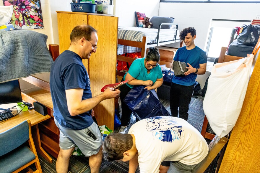 First-year student Tebau Daniels, far right, a mechanical engineering major from Baltimore, Md. moves into his RIT dorm in 2025.  Also pictured, from left: father Elliot, brother, Mike; mother, Melissa in 2025.