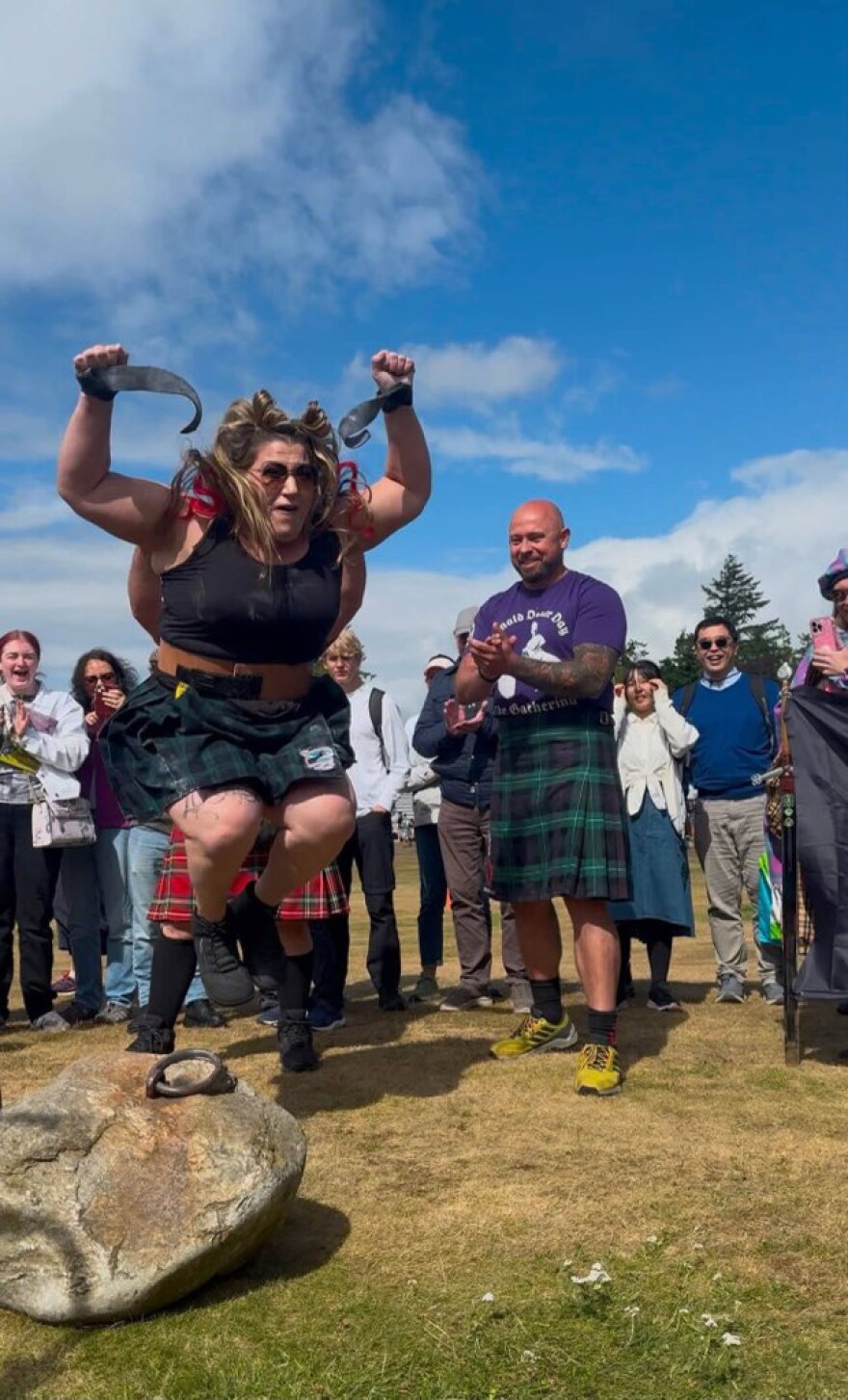 Teresa Troiani jumps in celebration after successfully lifting the Dinnie Stones.