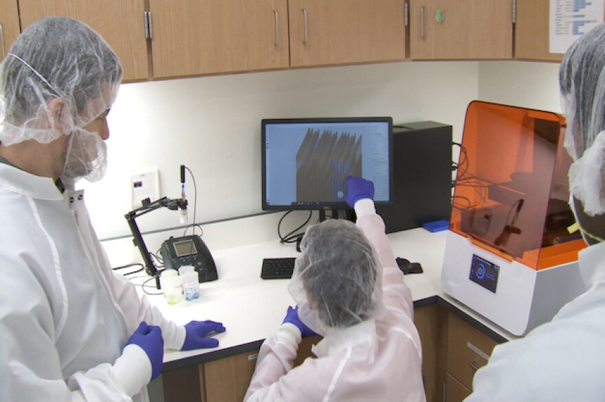 Gumennik's students look at testing swabs to be printed at their lab.