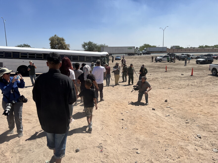 Migrants are boarded into Border Patrol buses to be taken to a processing center on May 10. 