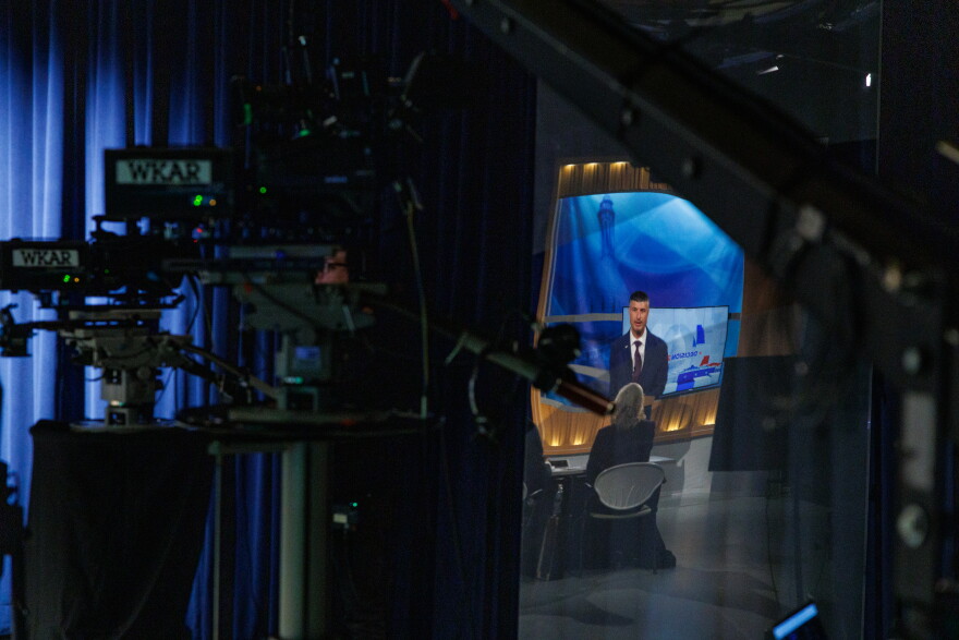 U.S. Rep. Tom Barrett, R-Charlotte, is reflected in a piece of glass in WKAR's studios in East Lansing, Mich., as he speaks during the first debate with Democratic nominee for U.S. House on Oct. 6, 2026.