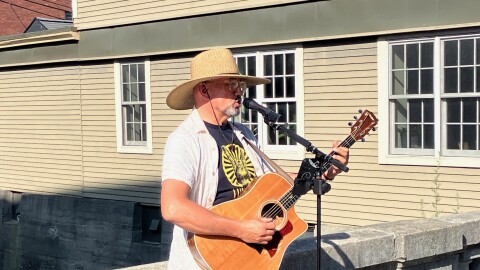Montpelier Mayor Marc Gwinn sings and plays his guitar for people attending the city's "Ramble" event.