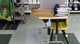FILE - Hand sanitizer is attached to a desk in a classroom at Aikahi Elementary School in Kailua, Hawaiʻi on Tuesday, July 28, 2020. (AP Photo/Jennifer Sinco Kelleher)