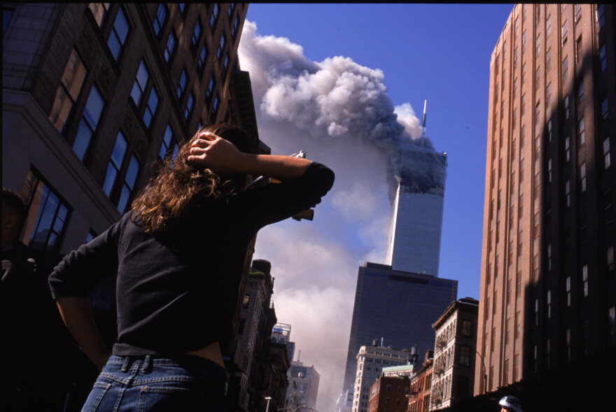 FILE: Shocked crowds of downtown Manhattanites observe the burning World Trade Center towers in New York City early September 11, 2001. Three hijacked planes crashed into major U.S. landmarks on the same day, destroying both of New York's twin towers and plunging the Pentagon in Washington into flames, in an unprecedented assault on key symbols of U.S. military and financial power.
