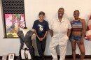 From left to right, mars patterson, Destiny Brady, and Fatima Laster pose around artwork that is part of the "This Is America Exibition.