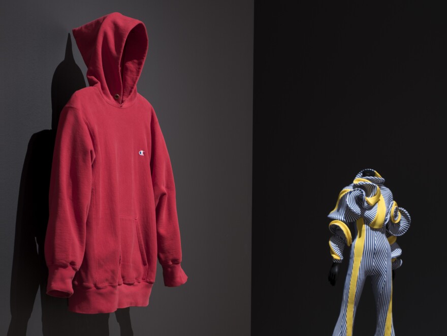 "Items: Is Fashion Modern?" takes up the entire 6th floor of MoMA and features objects that range from futuristic to completely ordinary. Pictured here: a Champion hoodie from the 1980s and Richard Malone's <em>Jumpsuit Specimen 2017</em>.