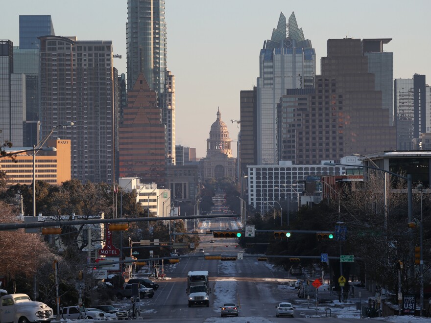 Vehicles drive along Congress Avenue that leads to the Texas Capitol building in Austin. Last August, Texas hired MSCI, a financial ratings firm that analyzes green investments, to aid it in drawing up a list of which firms it should boycott, public records obtained by Floodlight show.