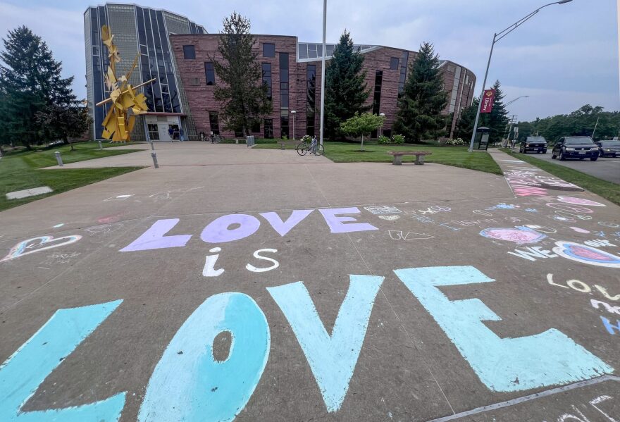 After a "rainbow story time" caught state officials' attention, Columbia residents wrote affirming messages on the sidewalk in front of the Daniel Boone Regional Library branch near downtown Columbia, Missouri.