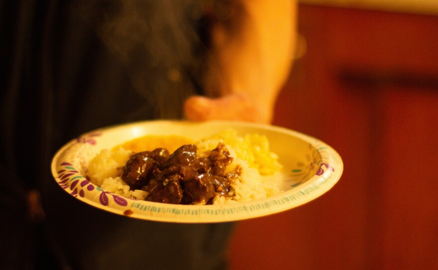 Melovidov holds a plate of fur seal and rice.