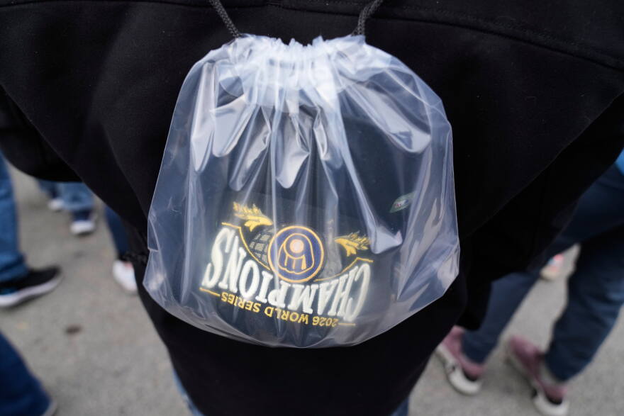 A fan arrives with a Milwaukee Brewers' Champions hat during the baseball team's World Series parade, Friday, Oct. 30, 2026, in Milwaukee. (AP Photo/Nam Huh)