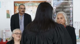 Upper Mattaponi councilwoman Desiree Dyer and Chief Frank Adams look on as Chief Justice Melissa Holds the Enemy Crow swears in newly elected Assistant Chief Lou Wratchford. (Photo by Pamela D'Angelo)
