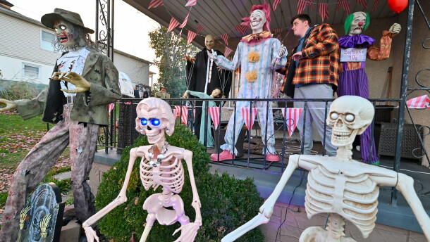 Will Kapmeyer, 15, adjusts one of the clowns on his front porch in Throop. His display will be open for visitors on Halloween.